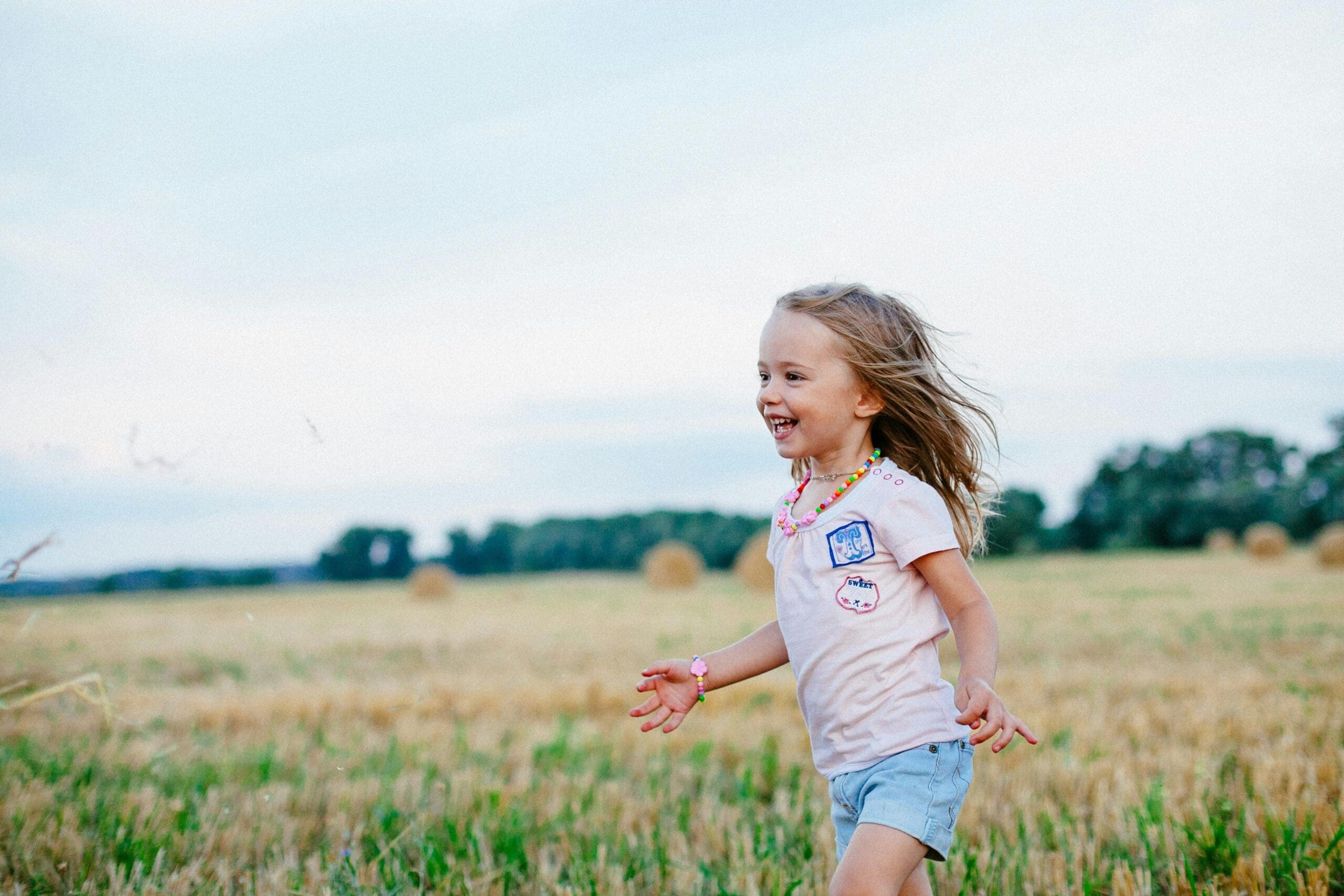 child running through field happy with good child mental health