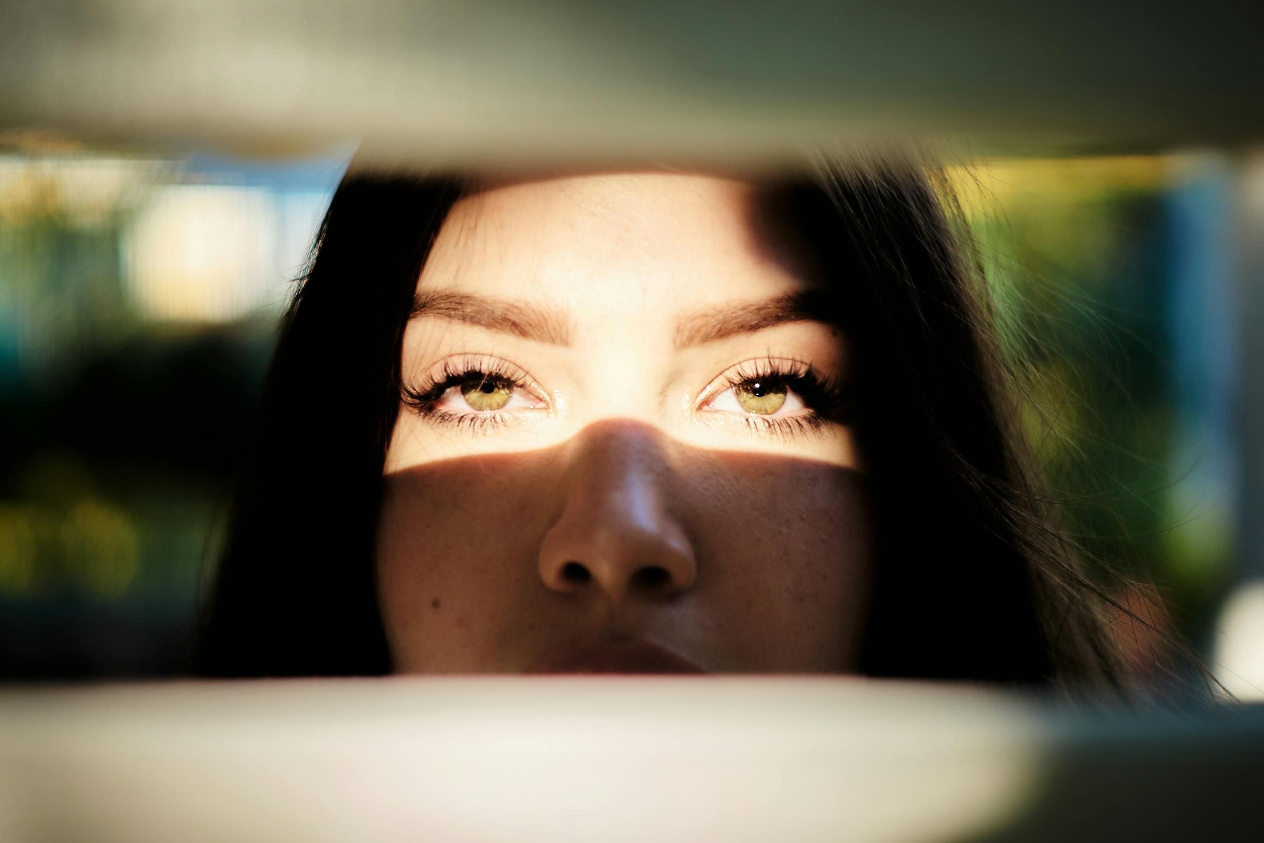 woman looking at audience with eyes in sun about to do emir therapy